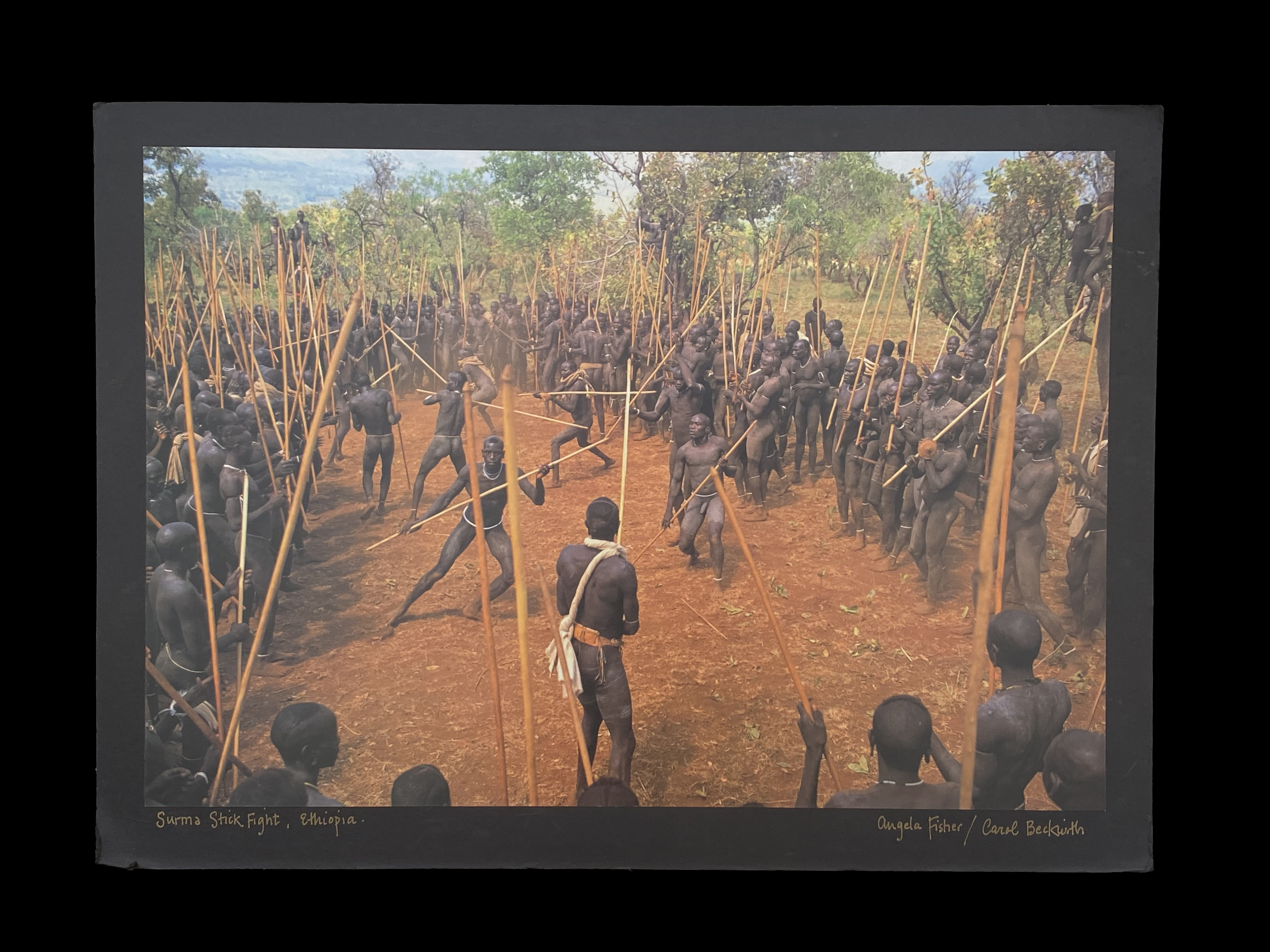 Mounted and Signed Photograph of Surma Stick Fight, Ethiopia - by Angela Fisher and Carol Beckwith