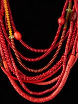 An eight-string necklace of various red tubular glass 